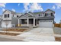 Charming two-story home featuring a two-car garage and inviting covered front porch at 9996 Racine St, Commerce City, CO 80022