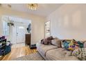 Inviting living room featuring hardwood floors and a view of the front door entryway at 2886 S Acoma St, Englewood, CO 80110