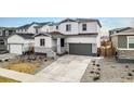 Two-story home with two car garage, and rock landscaping in the front yard at 1408 Brookfield Pl, Lafayette, CO 80026