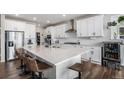 Bright, spacious kitchen with white cabinets, large island, stainless steel appliances and bar stool seating at 1408 Brookfield Pl, Lafayette, CO 80026