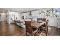 Bright kitchen featuring an island with bar seating, stainless steel appliances, and a dining area at 1408 Brookfield Pl, Lafayette, CO 80026