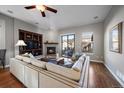 Living room with hardwood floors, fireplace and sliding glass doors to patio at 10366 Bluffmont Dr, Lone Tree, CO 80124