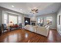 Bright living room with hardwood floors, fireplace, and access to backyard at 10366 Bluffmont Dr, Lone Tree, CO 80124