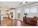 Bright kitchen area with white cabinetry, stainless steel appliances, and a door to a private outdoor deck at 36901 View Ridge Dr, Elizabeth, CO 80107