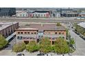 An aerial shot reveals modern condominiums with private balconies, nestled within a vibrant urban neighborhood setting at 3295 Blake St # 301, Denver, CO 80205