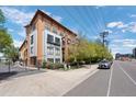 Modern condo building featuring balconies, large windows, and a gated entrance, showcasing contemporary architectural design at 3295 Blake St # 301, Denver, CO 80205