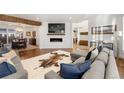 Open concept living room with hardwood floors and a cozy fireplace at 2805 E 4Th Ave, Denver, CO 80206