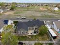 Aerial view of backyard featuring a small patio, trampoline, white fence, and mature trees at 5708 Wetland Loop, Frederick, CO 80504