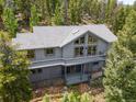 Beautiful mountain home with a large deck and picture windows to capture nature's beauty and serenity at 6882 Snowshoe Trl, Evergreen, CO 80439