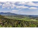 Expansive mountain vista showcasing the natural beauty of the surrounding landscape at 6882 Snowshoe Trl, Evergreen, CO 80439