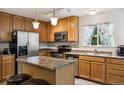Inviting kitchen with stainless appliances, island with seating, and ample cabinet space at 23535 E Platte Dr # A, Aurora, CO 80016