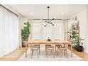 Dining area featuring a modern chandelier, natural lighting, and stylish décor at 1983 S Logan St, Denver, CO 80210