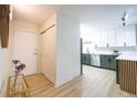 Hallway leading to modern kitchen featuring white cabinets and stainless steel appliances at 3450 S Poplar St # 307, Denver, CO 80224