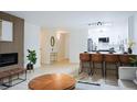 Open-concept living area with a fireplace, kitchen with bar seating, and modern design at 3450 S Poplar St # 307, Denver, CO 80224