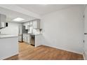 Bright kitchen with white cabinets, stainless steel appliances, and hardwood floors at 921 S Zeno Way # 201, Aurora, CO 80017
