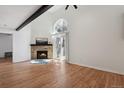 Living room features a stone fireplace, wood floors, vaulted ceilings, and lots of natural light at 921 S Zeno Way # 201, Aurora, CO 80017