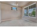 Empty bedroom with carpet flooring, neutral walls, a modern light fixture and a large window at 23957 E Rocky Top Ave, Aurora, CO 80016