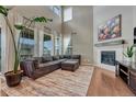 Spacious living room with fireplace, large windows, hardwood floors and stylish decor at 23957 E Rocky Top Ave, Aurora, CO 80016