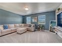 Comfortable living room with neutral tones, a plush sectional sofa, and plenty of natural light at 23957 E Rocky Top Ave, Aurora, CO 80016