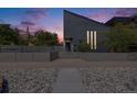 Modern home featuring a landscaped front yard with a secure fence and unique architectural design at 2801 Lawrence St, Denver, CO 80205