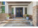 Elegant entryway with double doors and stone detailing at 967 Country Club Pkwy, Castle Rock, CO 80108