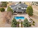 Overhead aerial showcases an inviting in-ground pool, hot tub, patio, and built-in kitchen area at 5375 Twilight Way, Parker, CO 80134