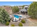 Aerial view of a stunning in-ground pool with a stone-surround and well-manicured landscaping at 5375 Twilight Way, Parker, CO 80134
