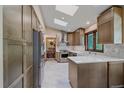 Bright kitchen features stainless steel appliances, quartz countertops, and ample cabinet space at 8944 W 66Th Pl, Arvada, CO 80004