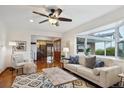 Bright living room with hardwood floors, a large window, and stylish decor, perfect for relaxing or entertaining at 4634 S Adobe Ct, Littleton, CO 80127