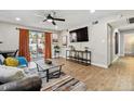 Bright and airy living room featuring hardwood floors and a sliding glass door to the balcony at 7755 E Quincy # 201, Denver, CO 80237