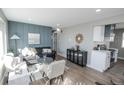 Cozy living room featuring stylish furniture, natural light, and seamless access to the modern kitchen at 4933 W 61St Ave, Arvada, CO 80003