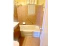 Neutral bathroom with tiled walls, bathtub with shower, and vanity sink at 3021 Locust St, Denver, CO 80207