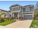 Charming two-story home with a well-manicured lawn, inviting entrance, and an attached two-car garage at 11569 Grape St, Thornton, CO 80233