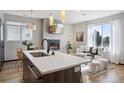 Bright and airy living room with a fireplace and large windows and island seating at 1277 Quitman St, Denver, CO 80204