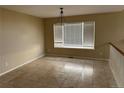 Open dining area with neutral paint, tile floors, and a large window at 20304 E 47Th Pl, Denver, CO 80249