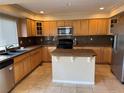 Spacious kitchen features wood cabinets, granite countertops, and an island at 20304 E 47Th Pl, Denver, CO 80249