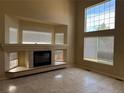Bright living room with a fireplace, tile flooring and large windows offering ample natural light at 20304 E 47Th Pl, Denver, CO 80249