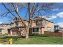 Charming home with mature trees, green lawn, and inviting curb appeal at 495 Bexley St, Highlands Ranch, CO 80126