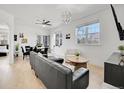 Bright living room featuring a modern chandelier, stylish leather sofa, and views from large windows at 12768 Ironstone Way # 204, Parker, CO 80134