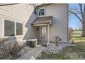 Townhouse entrance with dormer window, leading to the front door, surrounded by neat landscaping at 2122 S Victor St # F, Aurora, CO 80014