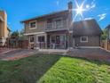 Backyard features a lawn and patio with a balcony, offering great outdoor living space at 15789 Sandtrap Way, Morrison, CO 80465