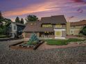 Charming two-story home featuring a unique stone facade, well-manicured lawn, and appealing landscaping at 15789 Sandtrap Way, Morrison, CO 80465