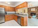 Kitchen showcases wooden cabinets, granite countertops, stainless steel appliances, and opens to the living room at 15789 Sandtrap Way, Morrison, CO 80465