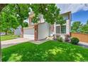 Inviting two-story home with a manicured lawn and a convenient two car garage at 9717 Castle Ridge Cir, Highlands Ranch, CO 80129