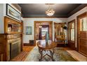 Elegant foyer featuring a grand round table, decorative fireplace, and ornate vintage light fixture at 1275 N Franklin St, Denver, CO 80218