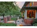 Charming covered porch with beautiful landscaping, manicured lawn, and brick walkway at 1275 N Franklin St, Denver, CO 80218