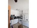 Bright kitchen featuring white cabinets and appliances with tile flooring at 2551 S Carson Way, Aurora, CO 80014