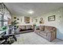 Inviting living room with neutral tile flooring and two comfortable sofas at 2551 S Carson Way, Aurora, CO 80014