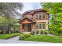 Charming home featuring a beautiful wood facade, brick accents, and a welcoming entryway with landscaped yard at 1410 S Elizabeth St, Denver, CO 80210