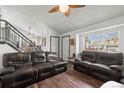 Living room with hardwood floors, and a large window letting in natural light, creating a comfortable area at 8571 S Estes St, Littleton, CO 80128